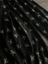 Load image into Gallery viewer, Embroidered CEY airflow woven: 2 YD CUT REMNANT Black white bows ⭐️
